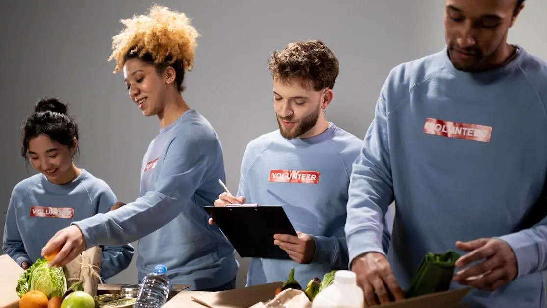 Diverse volunteers pack food donations at food bank, showcasing teamwork and community service.