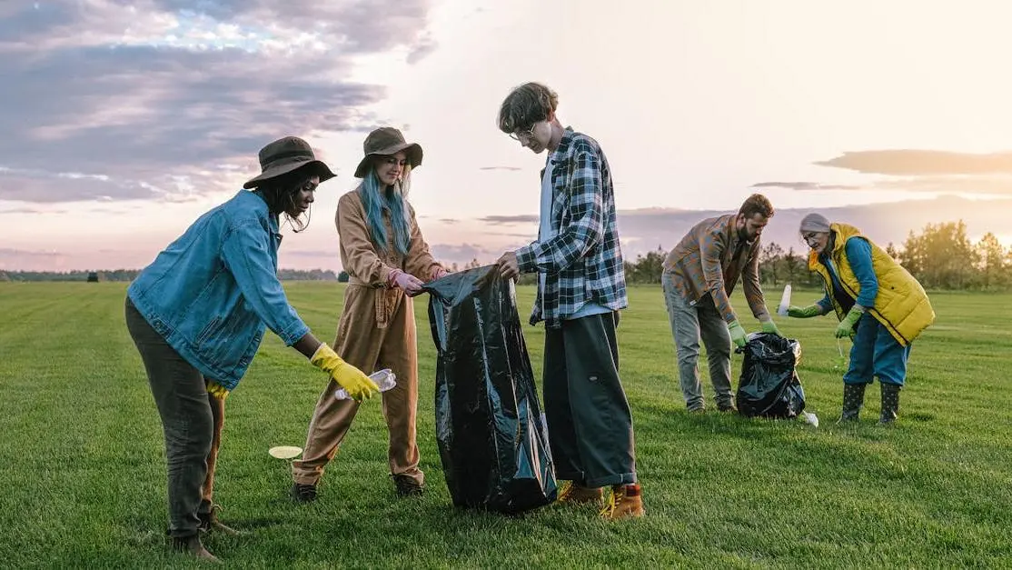 Teens volunteering to collect trash outdoors, highlighting volunteer opportunities for teens