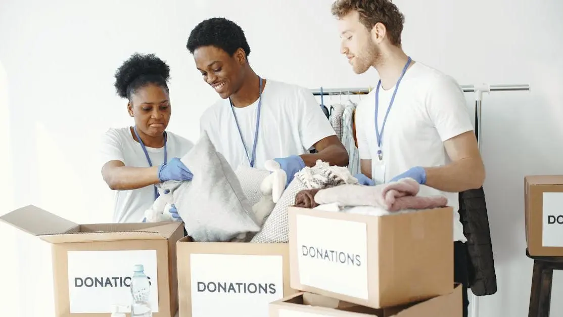 High school students organizing clothing donation boxes as volunteer opportunities