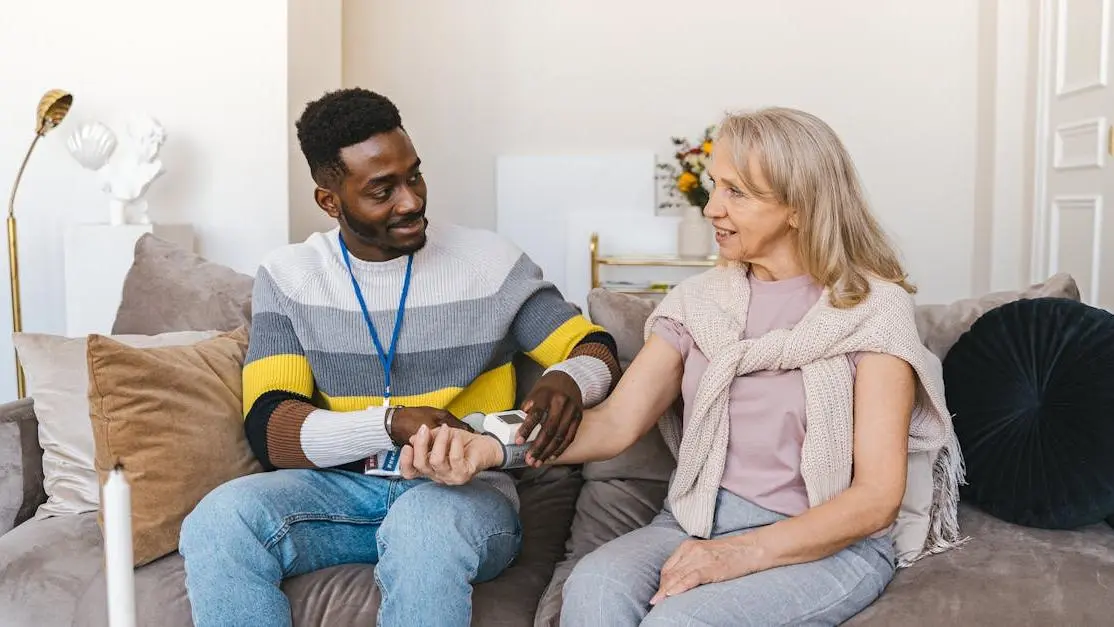 Volunteer takes an elderly woman’s blood pressure, highlighting medical volunteer opportunities