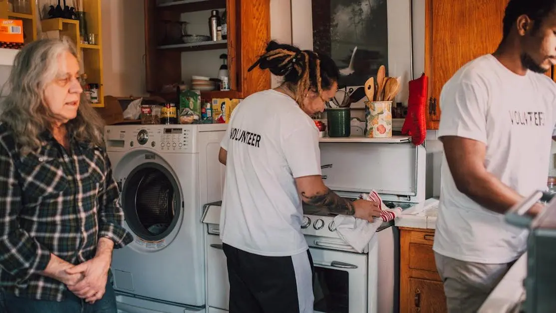 Volunteers cooking in a community kitchen for local charity, highlighting volunteer jobs overseas