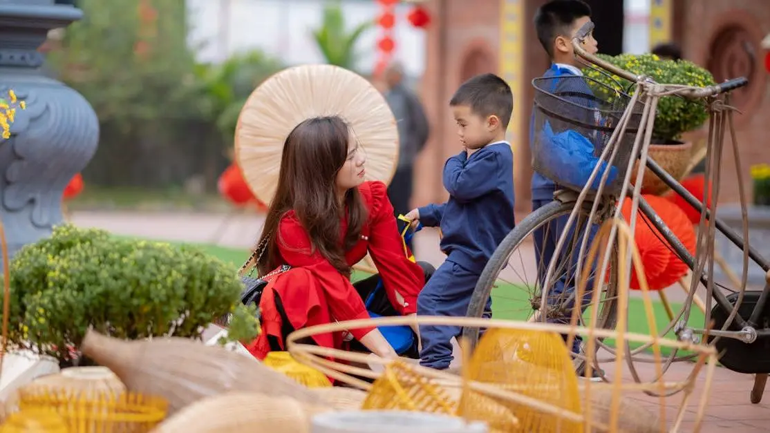 Young woman engaging with two children at a traditional outdoor market during volunteer work abroad