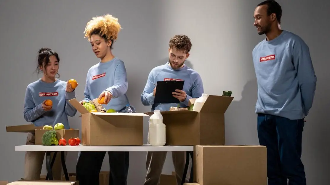 Volunteers packing food donations indoors, illustrating volunteer work examples for resume