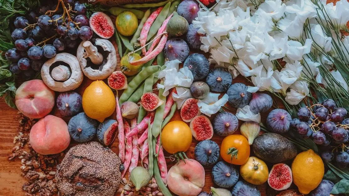 Colorful fresh produce and bread on a wooden table, symbolizing community food bank volunteering
