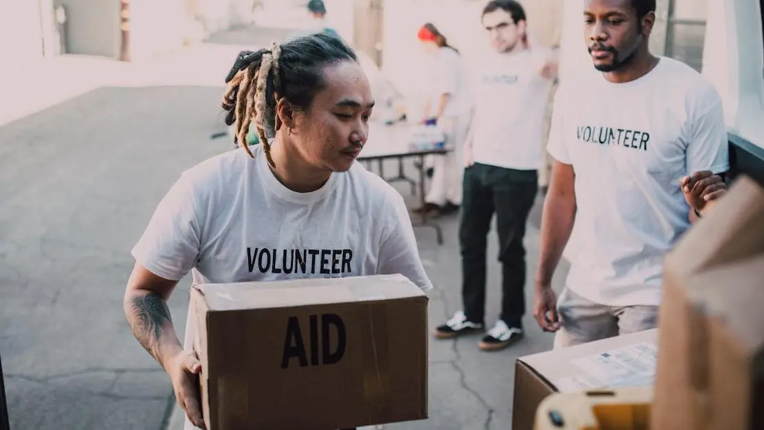 Good will volunteer team unloading aid from van, showing teamwork and community support