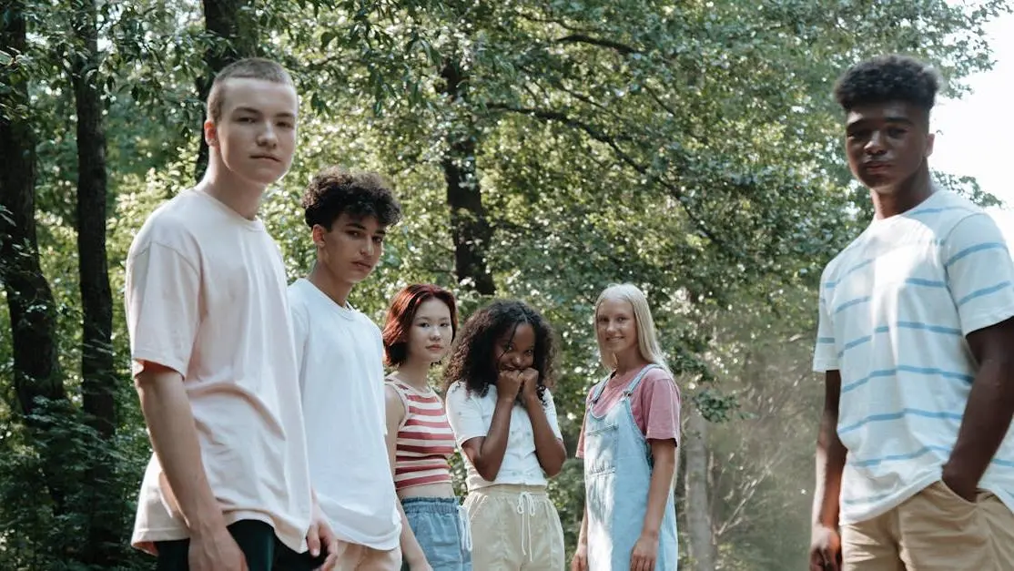 Teens in a lush forest volunteering together, showcasing volunteer activities for teens outdoors