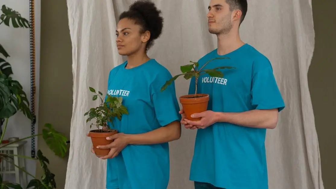 Young volunteers holding potted plants, volunteering in community service for environmental awareness.