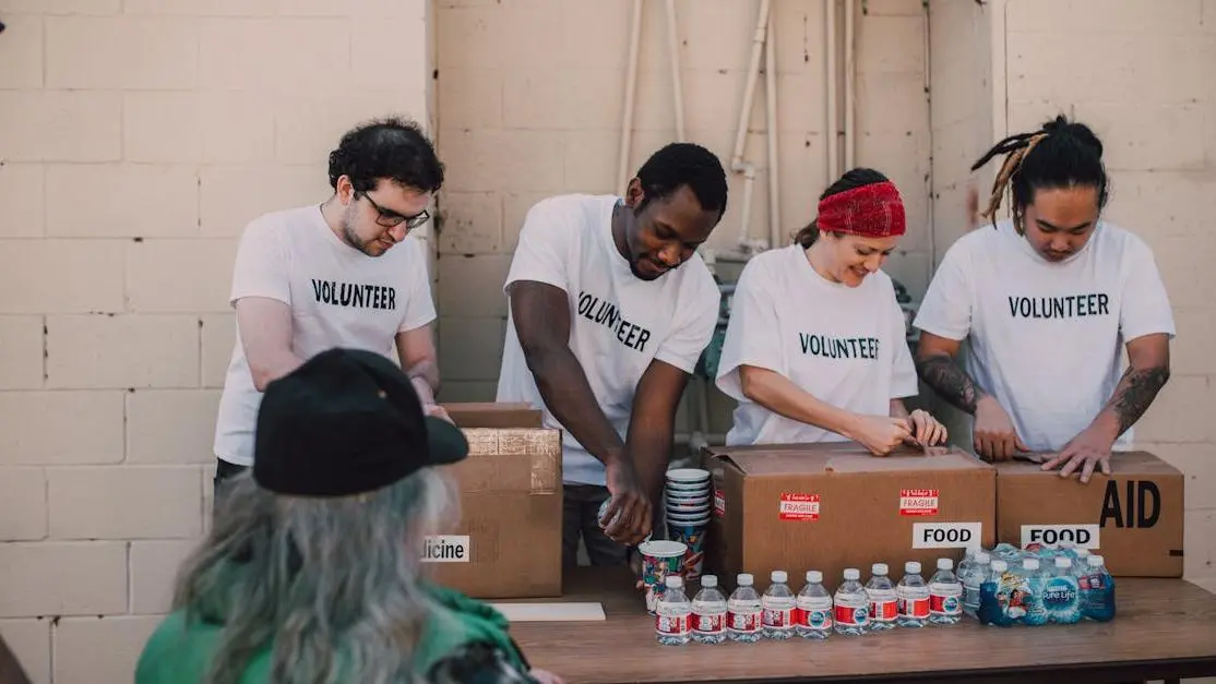 YMCA volunteer opportunities: volunteers organize and distribute aid packages and bottled water outdoors