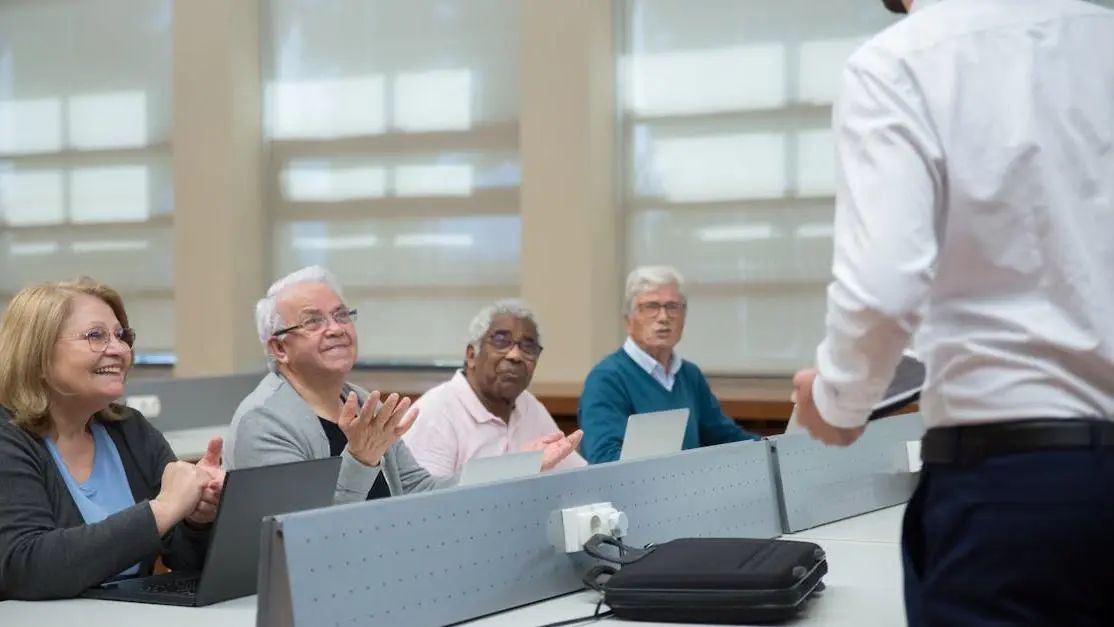 Senior adults in a classroom computer class exploring IT volunteer opportunities