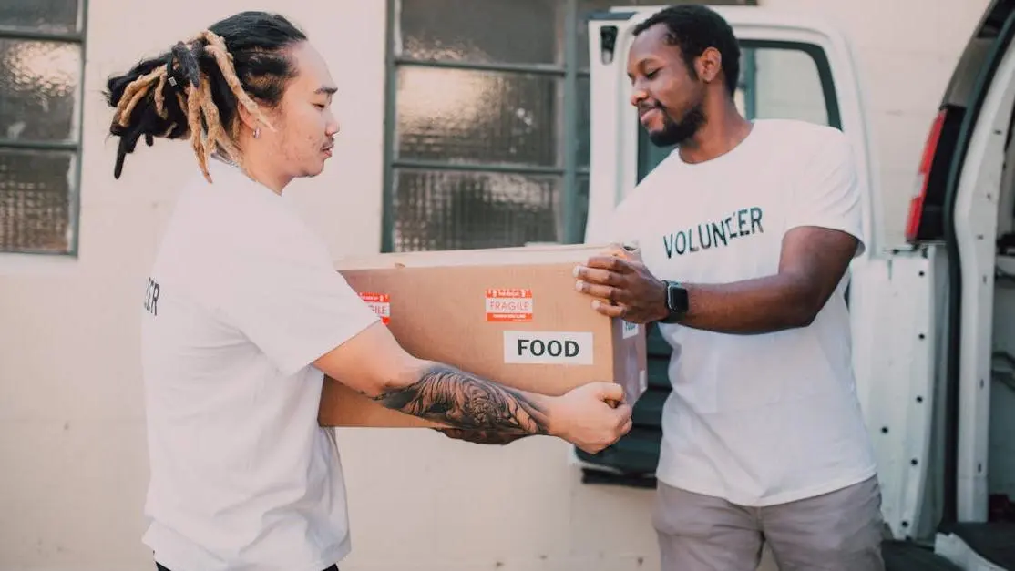 Volunteers unloading food box from van for community support, volunteer opportunities non profit organizations